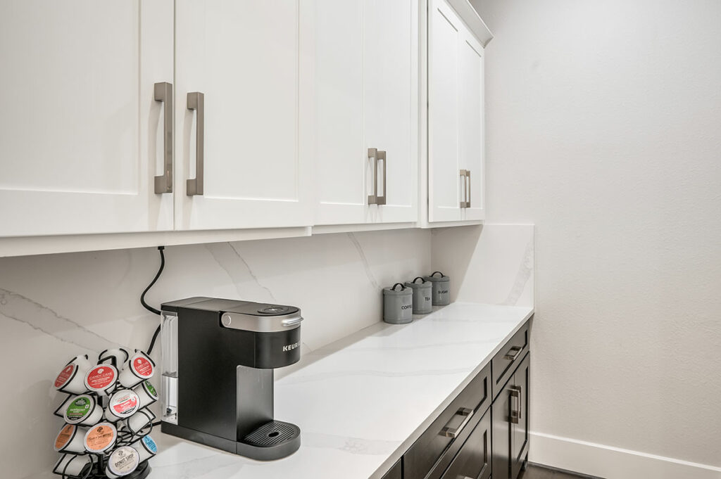 Pacious Butler’s Pantry Featuring Built-in Appliances And Farmhouse Sink