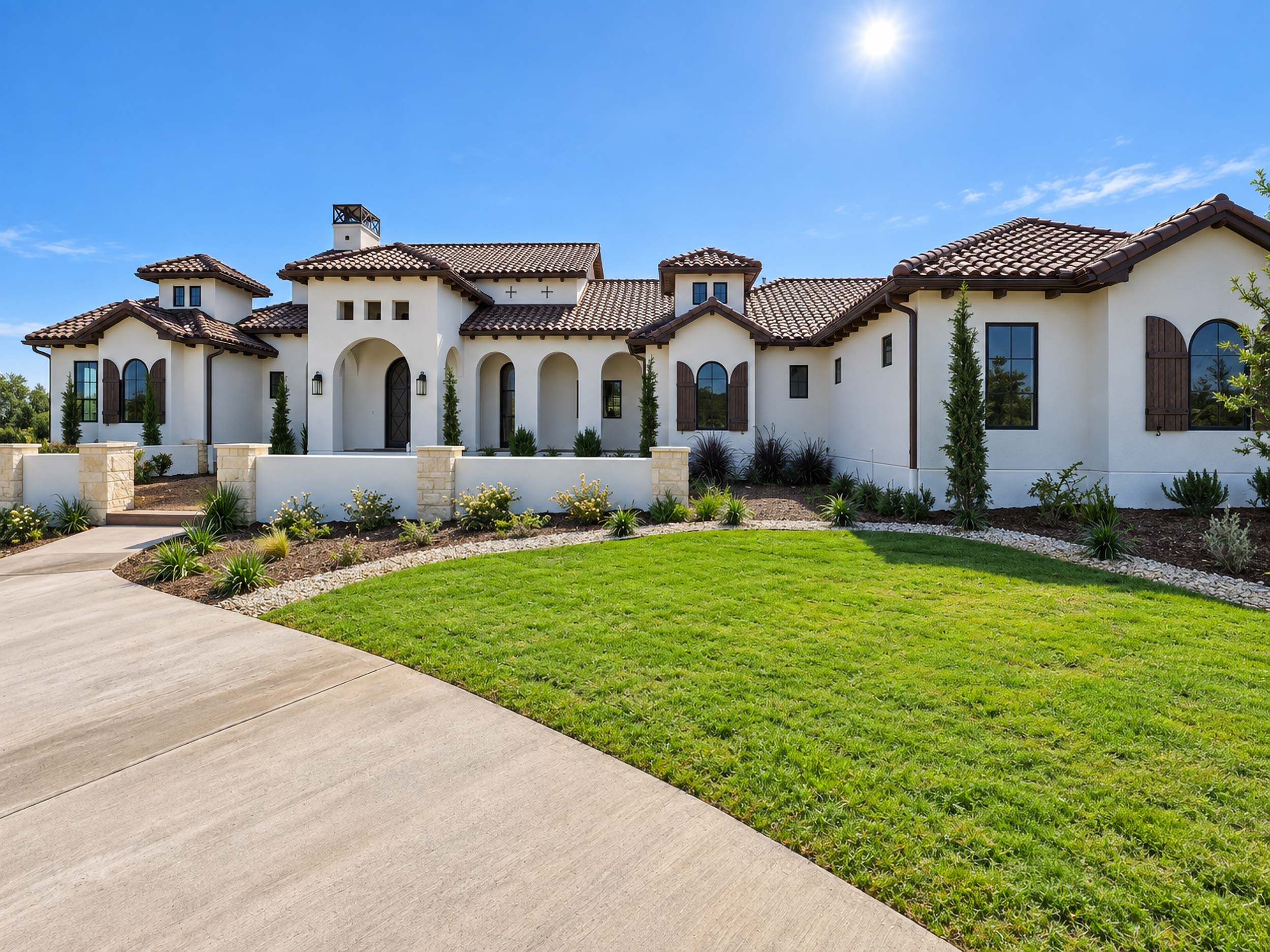 Mediterranean-style Sierra Classic custom home exterior with clay tile roof and manicured lawn in Texas